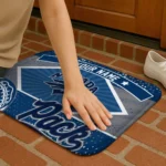 personalized-nevada-wolf-pack-football-crest-blue-black-doormat-best-selling.webp