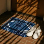 personalized-nevada-wolf-pack-football-crest-blue-black-doormat-best-selling.webp