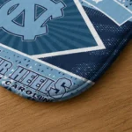 personalized-north-carolina-tar-heels-football-crest-light-blue-black-doormat-best-selling.webp