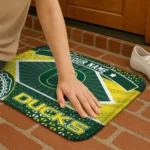 personalized-oregon-ducks-football-crest-green-black-doormat-best-selling.webp