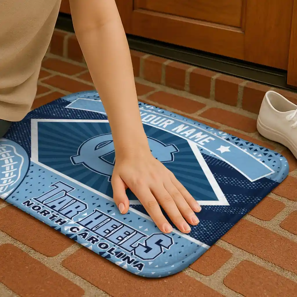 personalized-north-carolina-tar-heels-football-crest-light-blue-black-doormat-premium-grade.webp