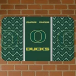 oregon-ducks-chevron-stack-green-doormat-best-selling.webp