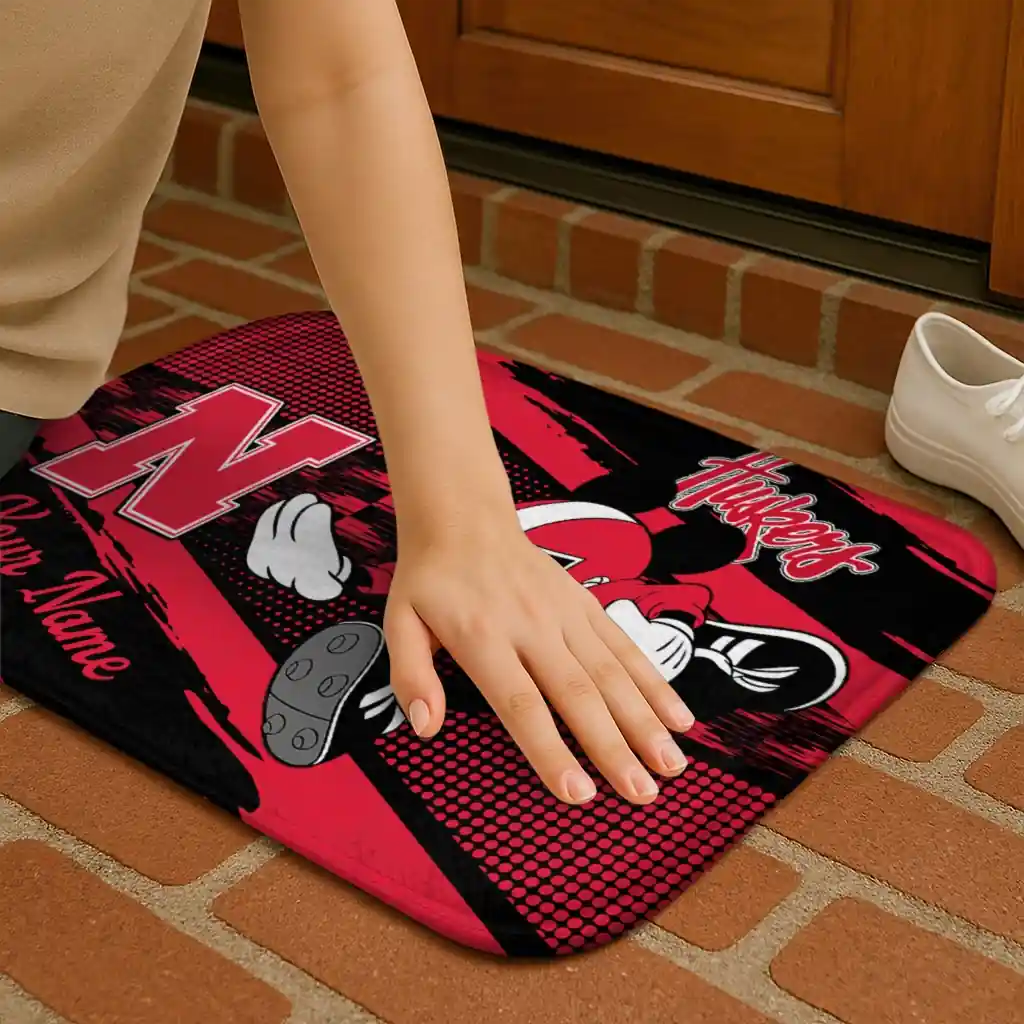 personalized-nebraska-cornhuskers-mickey-quarterback-red-black-doormat-premium-grade.webp